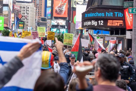 Photo for Pro-Palestinian Rally and March Held In New York's Times Square As Israel Declares War On Hamas In The Middle East. October 8, 2023, New York, New York, USA: Counter-protesters holding Israeli flags are separated by NYPD officers at a rally - Royalty Free Image
