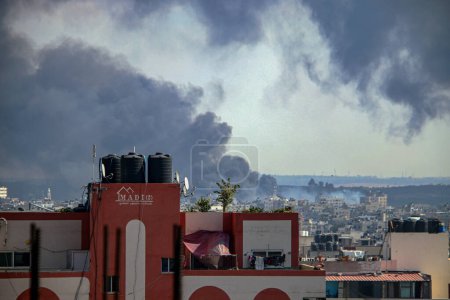 Photo for Smoke and flames billow after Israeli forces hit a high-rise tower in Gaza City. October11, 2023, Gaza, Palestine: Palestinian militants have started a "war" against Israel, infiltrating by air, sea and land from the blockaded Gaza Strip - Royalty Free Image
