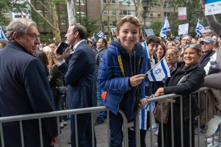 Photo for Rally And Vigil Held In New York City To Stand With Israel After Hamas Attack. October 10, 2023, New York, New York, USA: A boy waves an Israeli flag at a New York Stands With Israel vigil and rally on October 10, 2023 in New York - Royalty Free Image