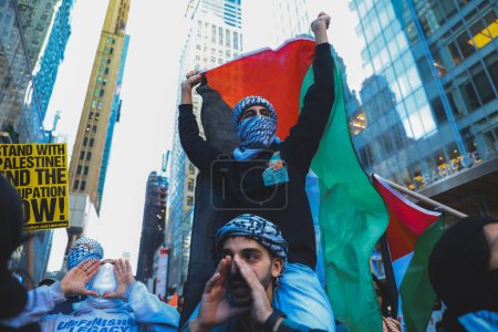 Photo for Palestinians Protest From Times Square to Israeli Consulate. October 13, 2023, New York, USA: Palestinian protestors march from Times Square to United Nations Headquarters to protest against Israels attacks on Palestinians - Royalty Free Image