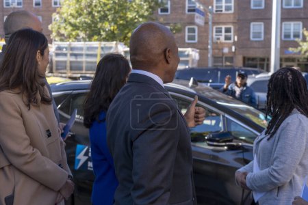 Photo for October 23, 2023 - New York, USA: Mayor Adams Signs Bill Paving Way For Electrification Of All City Government Vehicles. New York City Mayor Eric Adams interacts with a pedestrian at NYCHA&#39;s Ravenswood Houses on October 23, 2003 - Royalty Free Image