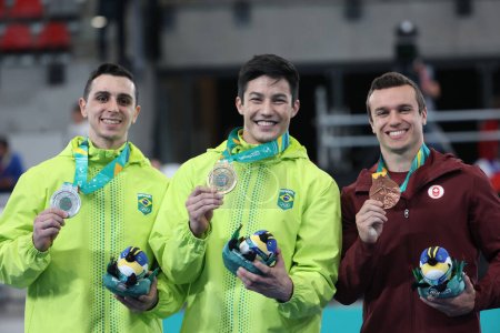 Photo for Santiago (Chile), 10/25/2023 -  Men's Artistic Gymnastics Final on Fixed Bar, with gold for Arthur Nory from Brazil, silver for Bernardo Miranda from Brazil and bronze for Rene Cournoyer from Canada - Royalty Free Image
