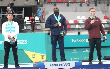 Photo for SANTIAGO, CHILE - 10/24/2023: Medal ceremony in the men's Anillos final with the American WHITTENBURG, D winning the gold, the Argentine VILLAFANE, D winning the silver and the Canadian Dolci Felix winning bronze at the Santiago National Stadium - Royalty Free Image