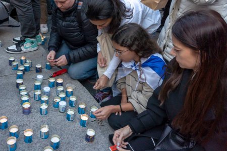Photo for Candlelight Vigil for Victims of Terrorist Attacks in Israel. November 1, 2023, New York, New York, USA: Israeli expats and supporters light candles at a Candlelight Vigil for the 1400 victims of the October 7 Hamas terrorist attacks in Israel - Royalty Free Image