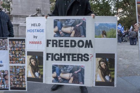 Photo for Candlelight Vigil for Victims of Terrorist Attacks in Israel. November 1, 2023, New York, New York, USA: Participant holds a sign debunking the claim that Hamas are freedom fighters during a Candlelight Vigil for the 1400 victims - Royalty Free Image