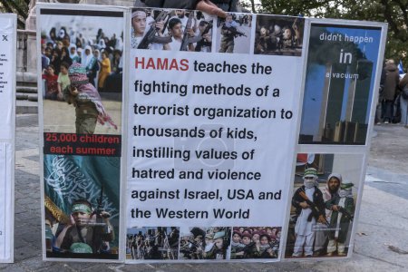 Photo for Candlelight Vigil for Victims of Terrorist Attacks in Israel. November 1, 2023, New York, New York, USA: Participant holds a sign saying Hamas teach thousands of kids to become terrorists at summer camps during a Candlelight Vigil for the 1400 - Royalty Free Image