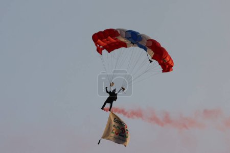 Photo for Vina del Mar, Chile - 04/11/2023: Match of the Brazil team against Chile, in the final of the Pan American Games, at the Sausalito Stadium in Vina del Mar, November 4, 2023. Man on parachute with the colors of Chile national flag in the sky - Royalty Free Image