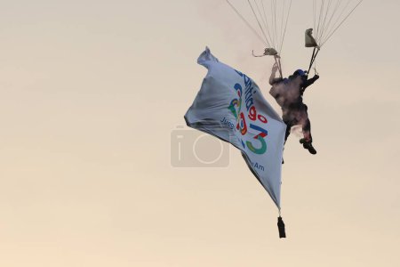 Photo for Vina del Mar, Chile - 04/11/2023: Match of the Brazil team against Chile, in the final of the Pan American Games, at the Sausalito Stadium in Vina del Mar, November 4, 2023. Man on parachute with the sign of Santiago 2023 Pan American Games - Royalty Free Image