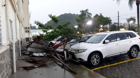 Photo for SANTOS (SP), BRAZIL - 03/11/2023 - WIND/DAMAGED/SANTA CASA/SANTOS - Winds of 100 kilometers per hour deroofed part of Santa Casa de Santos, on the coast of Sao Paulo and damaged a dozen parked cars. - Royalty Free Image