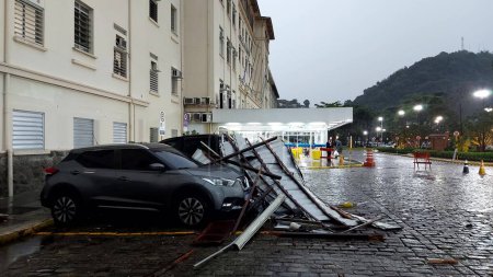 Photo for SANTOS (SP), BRAZIL - 03/11/2023 - WIND/DAMAGED/SANTA CASA/SANTOS - Winds of 100 kilometers per hour deroofed part of Santa Casa de Santos, on the coast of Sao Paulo and damaged a dozen parked cars. - Royalty Free Image