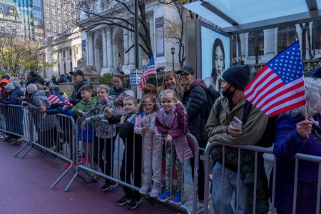 Photo for Veteran's Day Parade Held In New York City. November 11, 2023, New York, New York, USA: Spectators hold sign and flags in the annual Veterans Day Parade on November 11, 2023 in New York City. Hundreds of people lined 5th Avenue - Royalty Free Image