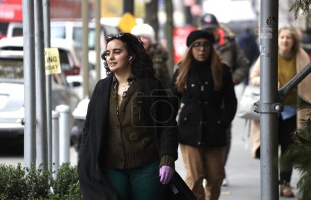 Photo for New Yorkers faced with 0.5C cold weather. November 28, 2023, New York, USA: New Yorkers and tourists are faced with 0.5C cold weather making them dressed up in winter clothes and with a little snowfall. - Royalty Free Image
