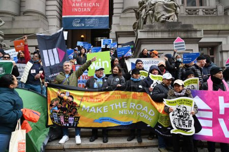 Photo for Various human rights organizations gather together in support of migrants rights and to add more homeless housing in New York. December 5, 2023, New York, U S A; At Bowling Green, in lower Manhattan, a coalition of advocate orgaizations - Royalty Free Image