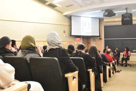 Photo for Audiences watches the speakers talk at the event. Noura Erakat, Marc Lamont Hill, and Nick Estes attend the Race, Liberation, and Palestine event at Rutgers University in New Brunswick, New Jersey. December 7, 2023, New Brunswick, New Jersey, USA - Royalty Free Image