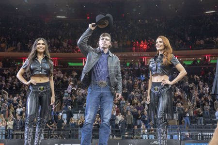 Photo for 2024 Professional Bull Riders At The Garden. January 6, 2024, New York, New York, USA: Conner Halverson (C), atop of event leaderboard, on stage at the end of second round of the Professional Bull Riders 2024 Unleash The Beast event - Royalty Free Image