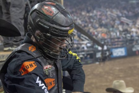 Photo for 2024 Professional Bull Riders Unleash The Beast At The Garden. January 7, 2024, New York, New York, USA: Eli Vastbinder gets ready to ride Roc Wit It with the help of other riders in the chute during the third round of the Professional Bull Riders - Royalty Free Image