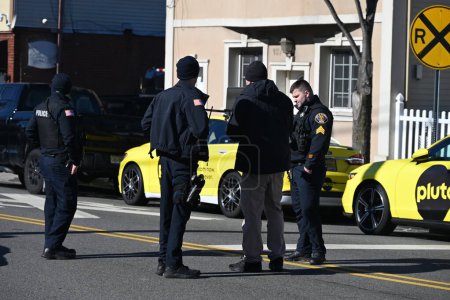 Photo for Police officers gather evidence at the crime scene in the daylight hours, Sunday morning. The Bergen County Prosecutors Office Major Crimes Unit and the Garfield Police Department are investigating a stabbing - Royalty Free Image