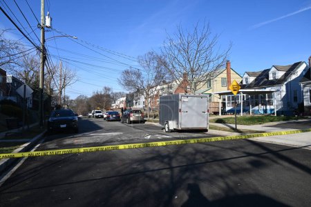 Photo for Investigators searching a residence and gathering evidence on Hanna Place Southeast in Washington, DC. February 15, 2024, Washington, DC, USA: Police are on the scene with an established crime scene Thursday morning and collecting evidence - Royalty Free Image