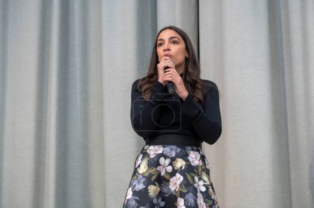 Photo for Rep. Alexandria Ocasio-Cortez Holds a Town Hall in Queens. February 22, 2024, New York, New York, USA: Rep. Alexandria Ocasio-Cortez delivers remarks at a Town Hall after five years of the Green New Deal at Astoria's PS 171Q - Royalty Free Image