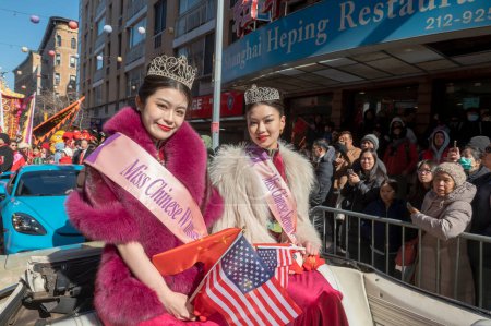 Photo for Chinatown Lunar New Year Parade. February 25, 2024, New York, New York, USA: 2023 Chinese beauty pageant winner Faye Liu and second runner up Kang Lai ride on a car at the annual Lunar New Year parade in Chinatown on February 25, 2024 - Royalty Free Image