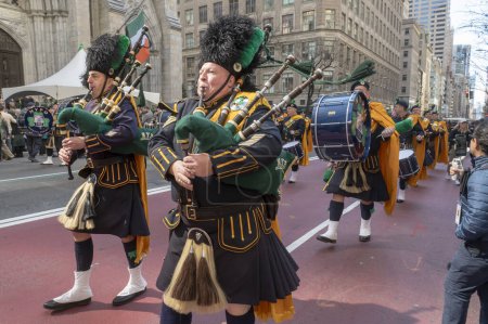 Photo for St. Patrick's Day Parade in New York City.  March 16, 2024, New York, New York, USA: Members of the NYPD Emerald Society Pipes Drums march in the St. Patrick's Day Parade along 5th Avenue - Royalty Free Image
