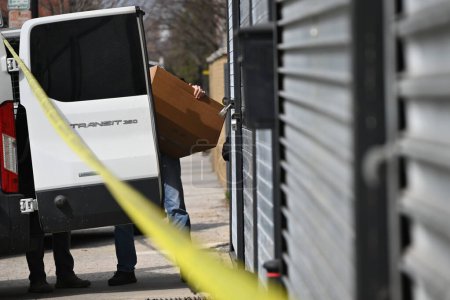 Photo for FBI agents gather at the crime scene at a warehouse to collect evidence following a double homicide in Mount Vernon, New York. Mount Vernon, New York, USA: On the morning of Tuesday, March 19, 2024, an attempted robbery and shooting - Royalty Free Image