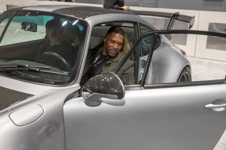 Photo for The New York International Auto Show 2024. March 27, 2024, New York, New York, USA: Michael Strahan  (R) receives delivery of his Daydream car during the International Auto Show press preview at the Jacob Javits Convention Center - Royalty Free Image
