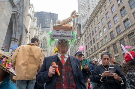 Photo for Easter Bonnet Parade. March 31, 2024, New York, New York, USA: A man in a lavishly decorated hat attends the Easter Parade and Bonnet Festival 2024 outside St. Patrick's Cathedral along Fifth Avenue - Royalty Free Image