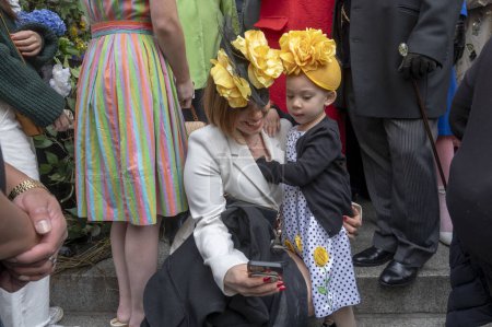 Photo for Easter Bonnet Parade. March 31, 2024, New York, New York, USA: A woman takes selfie with her daughter at the Easter Parade and Bonnet Festival 2024 outside St. Patrick's Cathedral along Fifth Avenue - Royalty Free Image