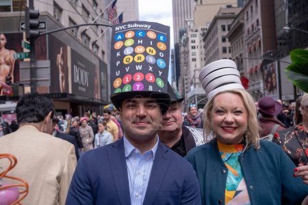 Photo for Easter Bonnet Parade. March 31, 2024, New York, New York, USA: A man in a subway motif decorated hat (L) attends the Easter Parade and Bonnet Festival 2024 outside St. Patrick's Cathedral - Royalty Free Image