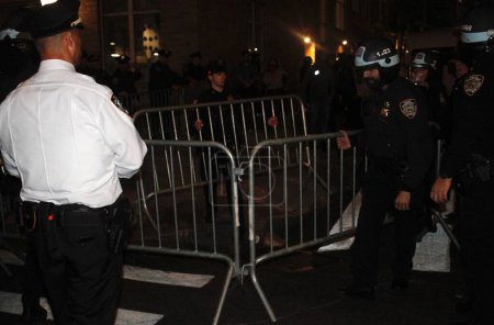 Photo for NYPD entered the Columbia University Campus and Clamped Down on Anti-Israel Protesters inside and also outside the college. April 30, 2024, New York, USA: NYPD got inside the Columbia University campus to dismantle the encampment - Royalty Free Image