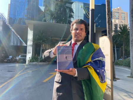 Photo for Sao Paulo (SP), Brazil 05/07/2024  Supporters of former President Jair Messias Bolsonaro, are on duty at the door of the Vila Nova Star Hospital, where the former president is admitted for routine examinations, in the city of Sao Paulo - Royalty Free Image