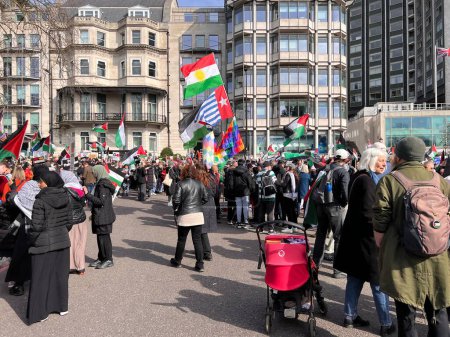 Photo for London, England, UK - March 9 2024: Peaceful anti- war coalition protest for ceasefire in Middle East from Hyde Park to US embassy groups include Muslims Jews Christians marching and chanting with flags and banners - Royalty Free Image