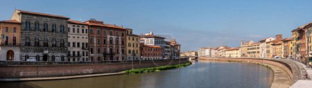 Old picturesque houses at the Arno river waterfront in Pisa, Italy