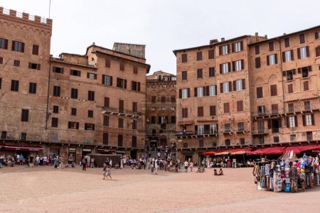 Photo for Old medieval brick houses surrounding the famous Piazza del Campo in the center of Siena, Italy - Royalty Free Image