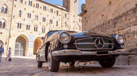 Photo for VOLTERRA, ITALY - OCTOBER 15, 2023 - A Mercedes Benz 190SL vintage car in the town center of Volterra in the Tuscany - Royalty Free Image