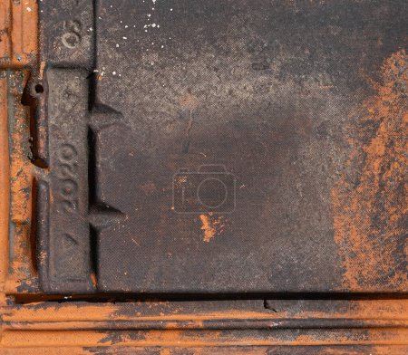 Foto de Close up terracotta roof tile with numbers imprinted and covered in black mildew stain background texture - Imagen libre de derechos