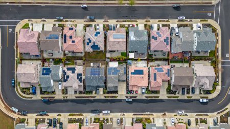 Top Down aerial photos over a community in California with homes with solar panels and roadways and parks