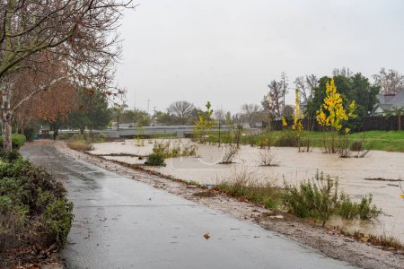 Photo for Brentwood, California USA 12 31 2022: Atmospheric river flooding Marsh Creek Canal in Brentwood, California - Royalty Free Image