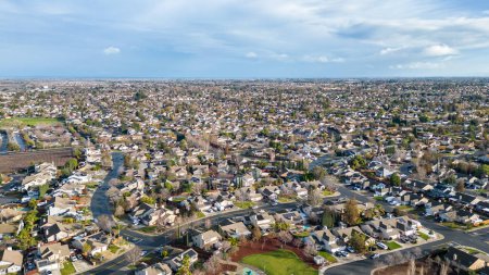 Photo for Aerial photos over a suburb in Oakley, California with homes, streets and parks with blue sky and room for text - Royalty Free Image