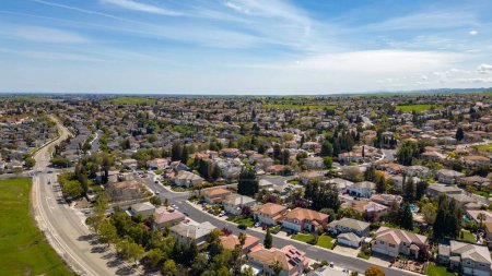 Photo for Drone photos over the city of Antioch, California on a beautiful sunny day with green hills, streets, houses, cars and solar. - Royalty Free Image
