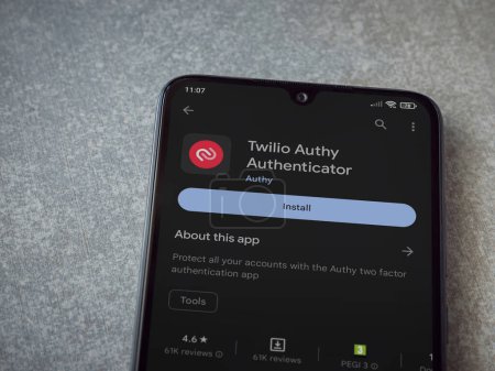 Foto de Lod, Israel - July 16,2023: Twilio Authy Authenticator app play store page on smartphone on ceramic stone background. Top view flat lay with copy space. - Imagen libre de derechos