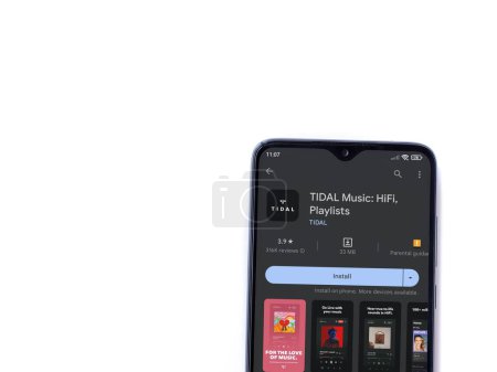 Foto de Lod, Israel - July 16,2023: TIDAL Music app play store page on smartphone on white background. Top view flat lay with copy space. - Imagen libre de derechos