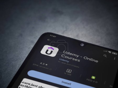 Foto de Lod, Israel - July 16,2023: Udemy app play store page on smartphone on a dark marble stone background. Top view flat lay with copy space. - Imagen libre de derechos