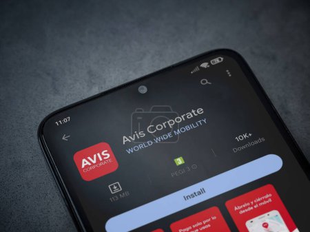 Photo for Lod, Israel - July 16,2023: Avis Corporate app play store page on smartphone on a dark marble stone background. Top view flat lay with copy space. - Royalty Free Image