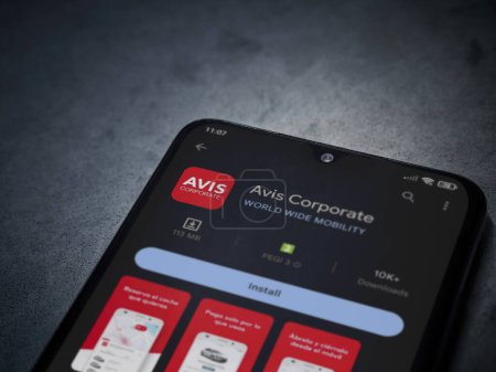 Photo for Lod, Israel - July 16,2023: Avis Corporate app play store page on smartphone on a dark marble stone background. Top view flat lay with copy space. - Royalty Free Image