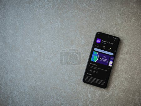Photo for Lod, Israel - July 16,2023: Rewire app play store page on smartphone on ceramic stone background. Top view flat lay with copy space. - Royalty Free Image