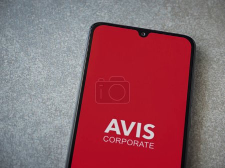Photo for Lod, Israel - July 16,2023: Avis Corporate app launch screen on smartphone on ceramic stone background. Top view flat lay with copy space. - Royalty Free Image