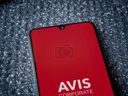 Photo for Lod, Israel - July 16,2023: Avis Corporate app launch screen on smartphone on metallic background. Close up top view flat lay. - Royalty Free Image