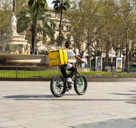 Photo for Caterer on bicycle in central Sevilla, Andalusia, Spain. - Royalty Free Image